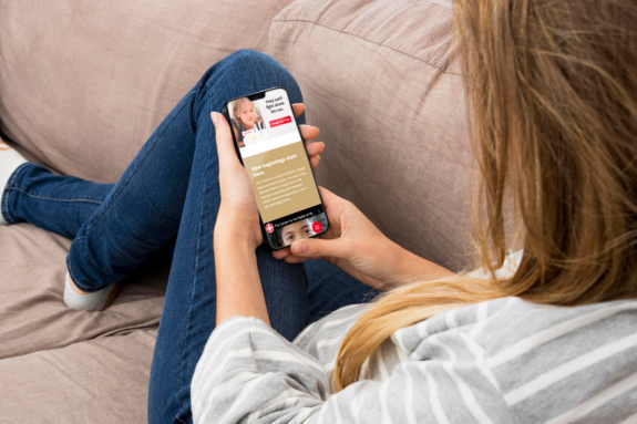 A woman browses the new Center for the Rights of Abused Children website on her smartphone.