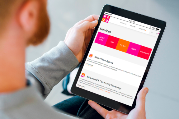 A man reads about the services offered on the new ROCO Films website while on his tablet.